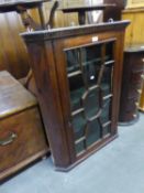 GEORGE III MAHOGANY FLAT FRONTED CORNER CUPBOARD, of typical form with dentil moulded cornice,