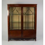 EARLY TWENTIETH CENTURY FIGURED MAHOGANY DISPLAY CABINET, the moulded oblong top above gazed sides