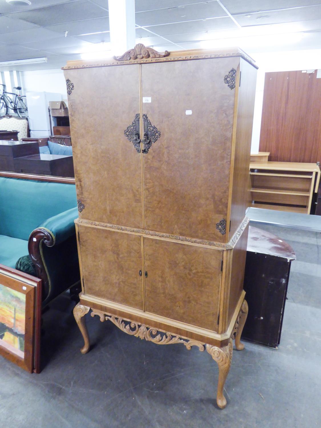 AN EPSTEIN STYLE 1930's COCKTAIL CABINET, RAISED ON CABRIOLE LEGS, WITH FITTED INTERIOR MIRROR AND