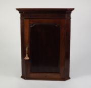 LATE GEORGIAN MAHOGANY FLAT FRONTED CORNER CUPBOARD, of typical form with dentil moulded cornice,