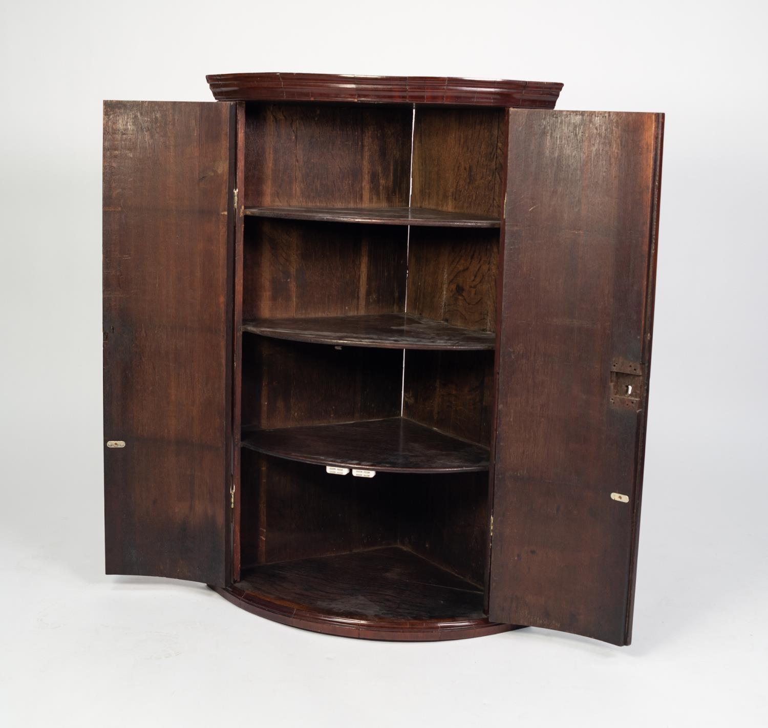GEORGE III MAHOGANY BOW FRONTED CORNER CUPBOARD, of typical form with moulded cornice, exposed brass - Image 2 of 2