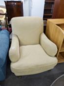 A GOOD QUALITY LARGE UPHOLSTERED ARMCHAIR, COVERED IN CREAM FABRIC (POSSIBLY LAURA ASHLEY)
