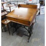 A VICTORIAN SLOPE TOP DESK, ON ADAPTED SINGER SEWING MACHINE CAST BASE