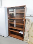 A WOOD EFFECT TALL DISPLAY CABINET, WITH TWO PAIRS OF FRAMELESS GLASS DOORS AND SHELF BELOW AND A