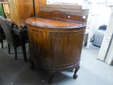 A GOOD QUALITY MAHOGANY DEMI-LUNE SINGLE DOOR CUPBOARD, RAISED ON CLAW AND BALL LEGS