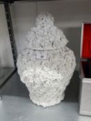 A LARGE WHITE POTTERY JAR AND COVER, TOTALLY COVERED WITH EMBOSSED ROSES, APPROX 17" HIGH