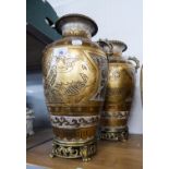 A PAIR OF TWO HANDLED POTTERY VASES, WITH GOLD AND CRACKLE EFFECT DECORATION, RAISED ON ORNATE METAL