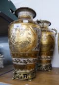 A PAIR OF TWO HANDLED POTTERY VASES, WITH GOLD AND CRACKLE EFFECT DECORATION, RAISED ON ORNATE METAL