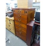 A TWENTIETH CENTURY REPRODUCTION SEVEN GRADUATED DRAWER NARROW CHEST (130cm high x 62cm wide x