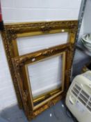 AN ORNATE GILT PICTURE FRAME AND A SIMILAR SMALLER PICTURE FRAME (2)