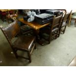 AN EARLY TWENTIETH CENTURY OAK TRESTLE END DINING  TABLE (6' X 2'8")  AND SIX OAK AND LEATHER