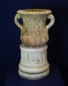 A RECONSTITUTED TWO HANDLE URN ON PEDESTAL BASE (60cm high)