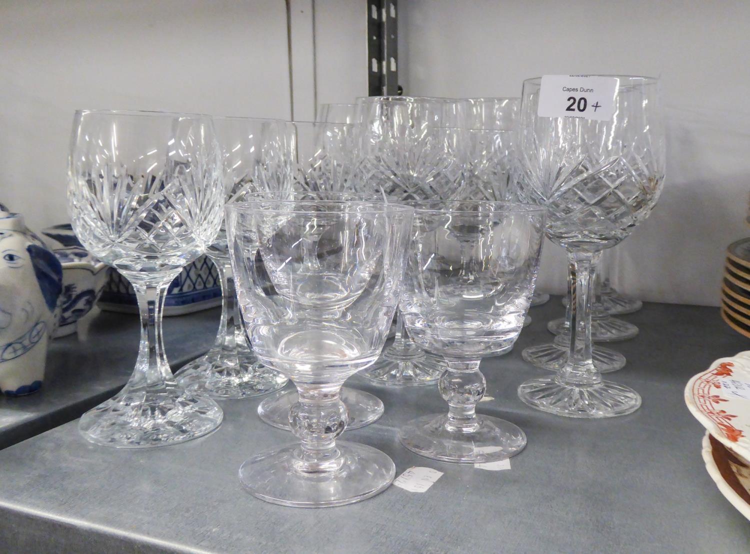 A SET OF EIGHT CUT GLASS TALL WINE GOBLETS, ON PANELLED AND WAISTED STEMS AND STAR CUT CIRCULAR