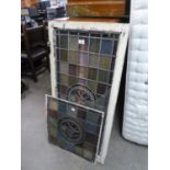 TWO STAINED GLASS PANELS WITH STYLISED FLORAL ROUNDELS, one in white painted window type frame,