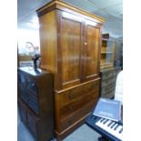 A VICTORIAN FLAME MAHOGANY LINEN PRESS, THE UPPER SECTION HAVING TWO PANEL DOORS, THE INTERIOR