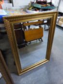 A RECTANGULAR GILT FRAMED WALL MIRROR  86.5cm x 61.5cm