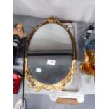 A SMALL OVAL WALL MIRROR WITH ORNATE GILT FRAME AND A LONG NARROW METAL TRAY WITH WOOD HANDLES