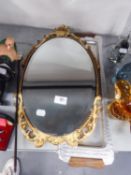 A SMALL OVAL WALL MIRROR WITH ORNATE GILT FRAME AND A LONG NARROW METAL TRAY WITH WOOD HANDLES