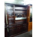 ?STAG? ?MINSTREL? MAHOGANY DISPLAY CABINET, THE UPPER PORTION WITH A GLAZED DOOR TO THE LEFT OF FOUR