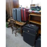 A MAROON FIBRE GLASS SMALL SUITCASE  AND SEVEN OTHER VARIOUS SIZED SUITCASES  (8)