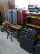 A MAROON FIBRE GLASS SMALL SUITCASE  AND SEVEN OTHER VARIOUS SIZED SUITCASES  (8)