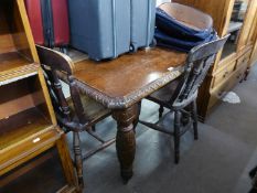 A VICTORIAN CARVED OAK EXTENDING DINING TABLE, RAISED ON CARVED BULBOUS LEGS AND A SET OF THREE