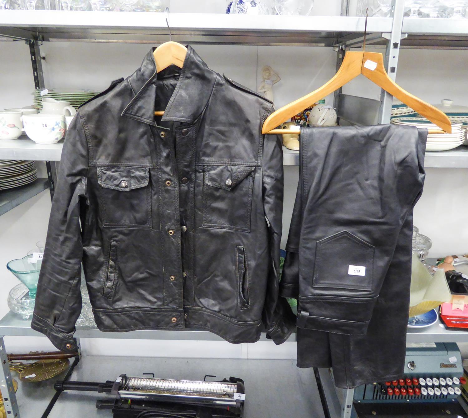 BLACK LEATHER JACKET, size 40, and a PAIR OF BLACK LEATHER BIKER TYPE TROUSERS, no size, (2)