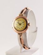 LADY'S 9ct GOLD VINTAGE WRISTWATCH with mechnical movement, decorated Arabic dial, circular case and