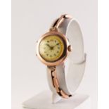 LADY'S 9ct GOLD VINTAGE WRISTWATCH with mechnical movement, decorated Arabic dial, circular case and