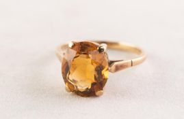 9ct GOLD DRESS RING with an oval citrine in a four claw setting, 3.8 gms, ring size R