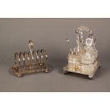 ELECTROPLATED FOUR DIVISION CRUET STAND, of square form with shell capped handle, nulled border