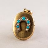 VICTORIAN GOLD COLOURED EMTAL OVAL LOCKET PENDANT, the front applied with a horseshoe shaped setting