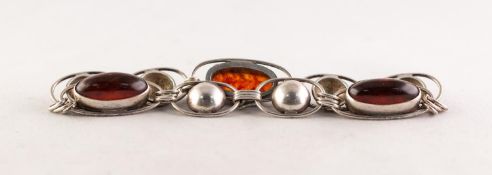 A SILVER NINE LINK BRACELET, three of the links set with cabochon oval amber, hook fastening