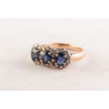 14ct GOLD, SAPPHIRE AND DIAMOND TRIPLE CLUSTER RING set with three oval sapphires surrounded by