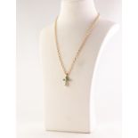 18ct GOLD, EMERALD AND DIAMOND CROSS PENDANT, set with a small centre diamond, approximately 0.07ct,