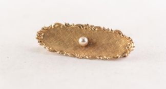 A GOLD CONCAVE OVAL BROOCH, textured with floral and scroll border and set with centre pearl, 1 3/4"