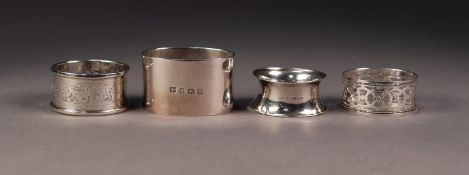 FOUR VARIOUS GEORGE V SILVER NAPKIN RINGS, including a HEAVY PLAIN, OVAL example, another pierced,