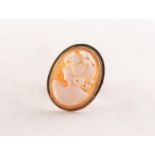 A SMALL OVAL SHELL CAMEO BROOCH/PENDANT carved with the head of a lady, in a 9ct gold frame, 7/8"