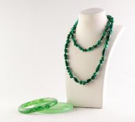 A SINGLE STRAND NECKLACE of round and oval malachite beads, 29" (74cm) and two jade green