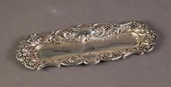 LATE VICTORIAN EMBOSSED AND PIERCED SILVER DRESSING TABLE TRAY, of shallow, rounded oblong form with