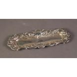 LATE VICTORIAN EMBOSSED AND PIERCED SILVER DRESSING TABLE TRAY, of shallow, rounded oblong form with