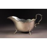 GEORGE VI SILVER SAUCE BOAT, of typical form with high scroll handle, moulded border and stepped