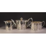 A GOOD QUALITY VICTORIAN SILVER THREE PIECE TEA SERVICE of serpentine oval form, each engraved and