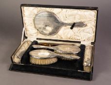 CASED GEORGE V ENGINE TURNED SILVER CLAD SIX PIECE DRESSING TABLE HAND MIRROR AND BRUSH SET BY A & J