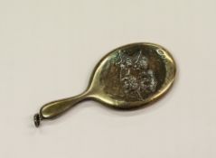 GEORGE V SILVER MINIATURE DRESSING TABLE HAND MIRROR, the back repousse with five cherub heads, ring