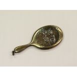 GEORGE V SILVER MINIATURE DRESSING TABLE HAND MIRROR, the back repousse with five cherub heads, ring