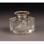 GEORGE V CUT GLASS INKWELL WITH SILVER COLLAR AND HINGED COVER, of square form with ?pie crust?