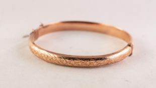 9ct GOLD HOLLOW D SECTION HINGE OPENING BANGLE, with foliate engraved top, Birmingham 1919, in