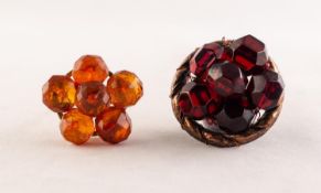 TWO CIRCULAR METAL FRAMED BROOCHES, each mounted with six faceted amber beads, one golden and one