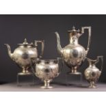 VICTORIAN SILVER FOUR PIECE ENGRAVED SILVER PEDESTAL TEASET, of ovoid form with angular scroll